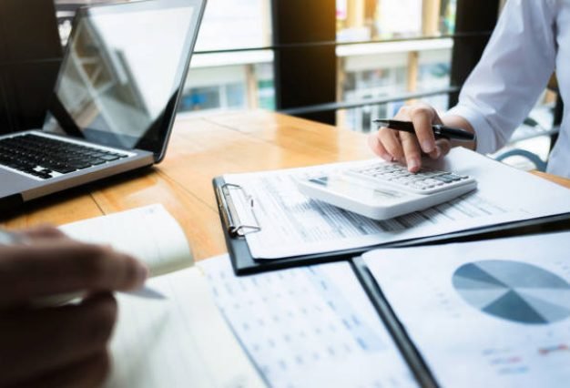 business audits using a calculator financial data investment fund at a workplace, wealth concept